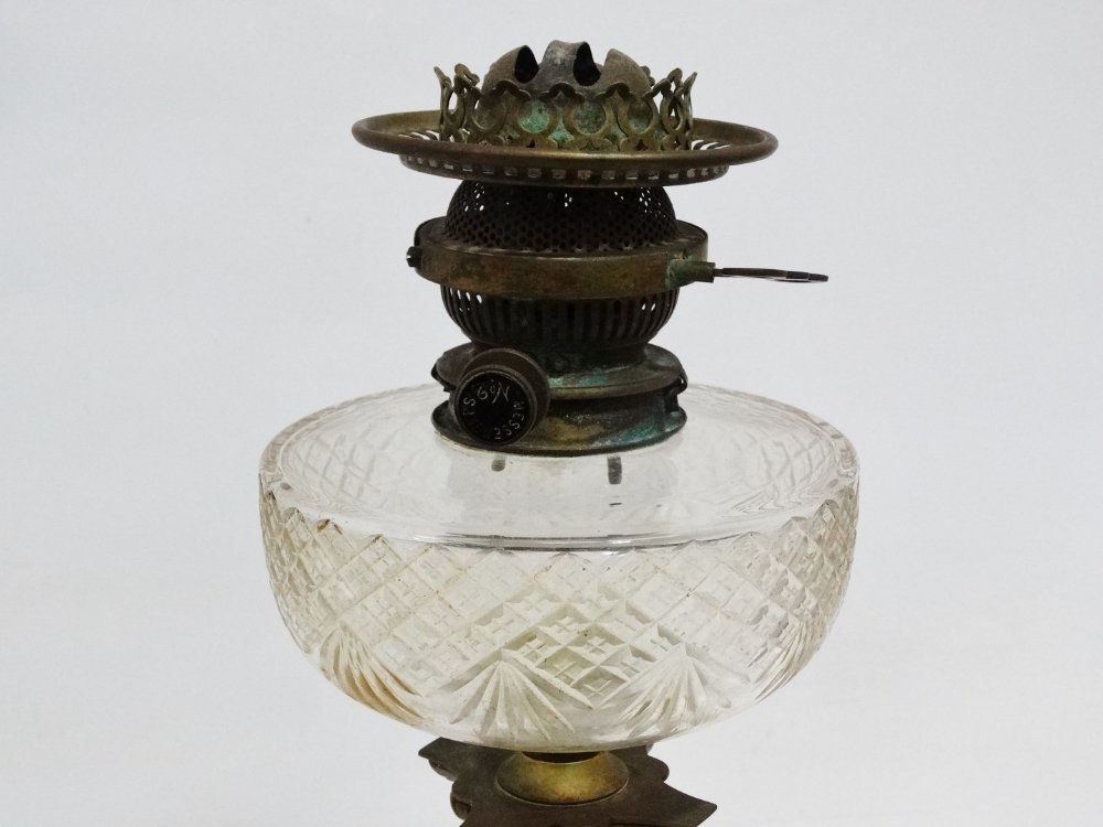 A Victorian brass oil lamp - the clear cut glass reservoir and etched glass globe, on a brass - Image 3 of 4