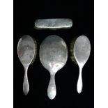 A George V silver four piece brush and mirror set - Birmingham/London 1911, engraved with