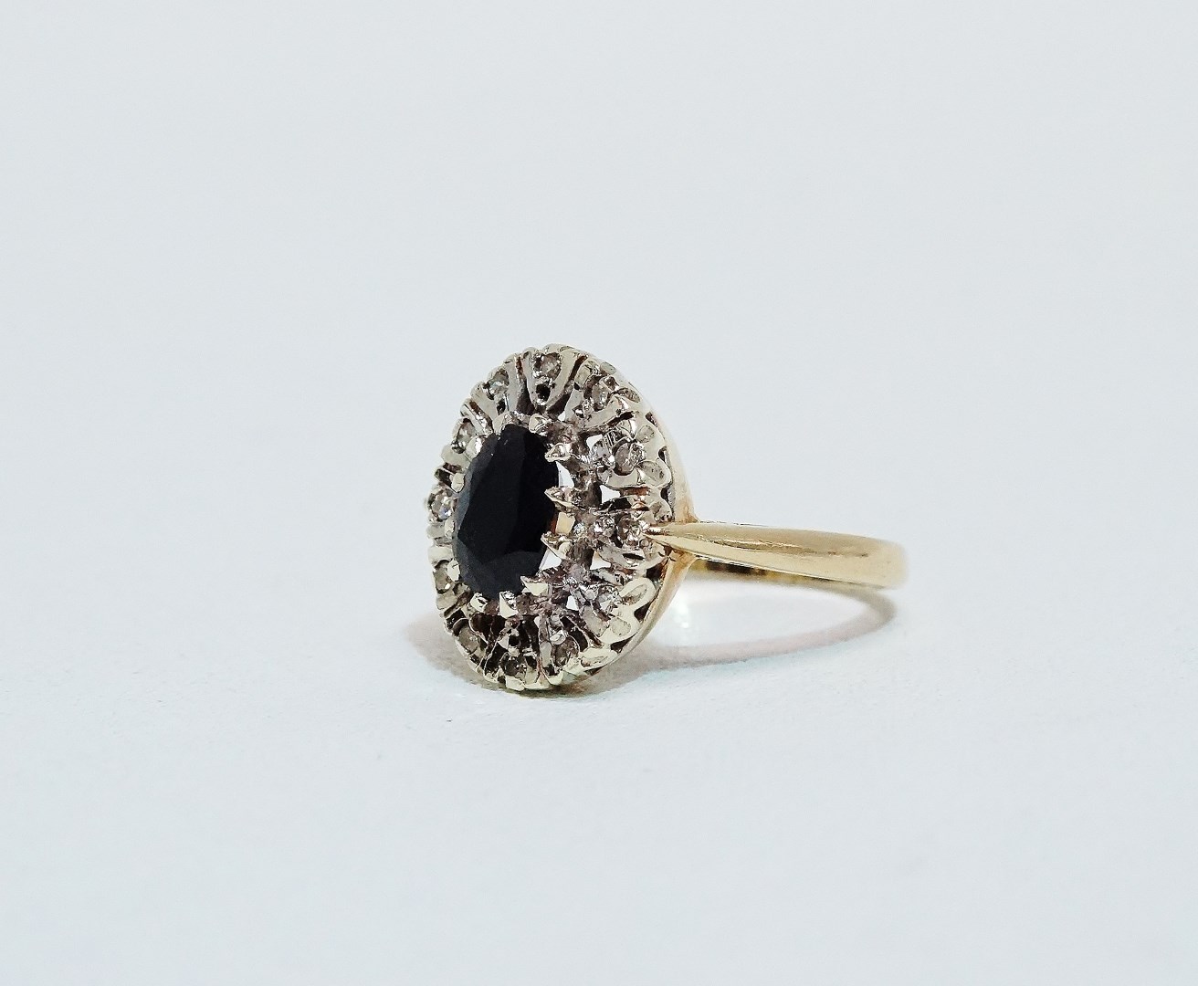 A sapphire and diamond dress ring - the central oval faceted stone within a band of claw set - Image 4 of 6