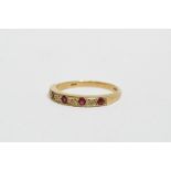 A five stone ruby and diamond dress ring - the gypsy set stones in a 9ct yellow gold band, size P/Q,