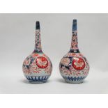 A pair of late 19th century Imari bottle vases - floral decorated in blue and red enamels, height