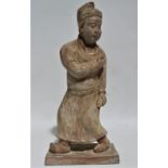 Terracotta figure - an oriental scholar standing on a rectangular base, height 45cm.