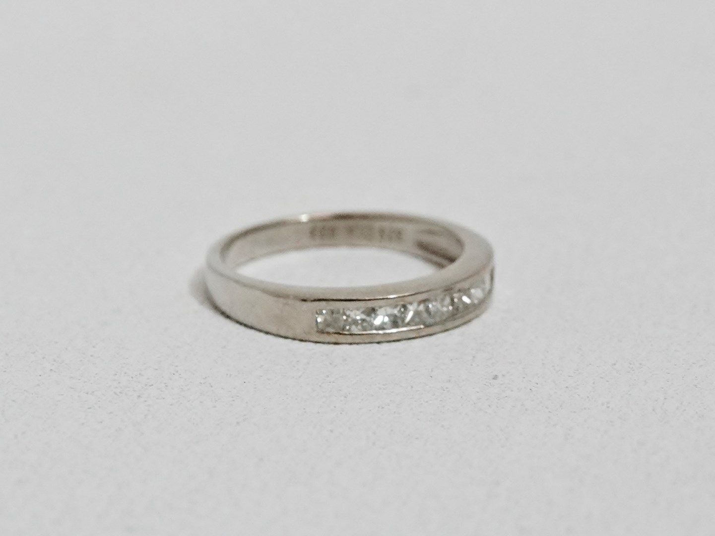 A diamond dress ring - the square cut stones channel set on a 9ct white gold band, size K/L, - Image 2 of 3