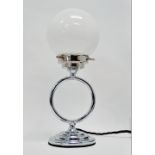 An Art Deco table lamp - of chrome annular form on a circular base with white globe shade, height