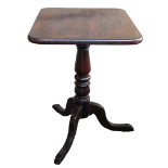 A 19th century mahogany tripod table - the rectangular tilt top above a turned support ending in