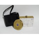 A Stretton powder compact - circular with Morris motors logo, together with a Volupte evening bag/