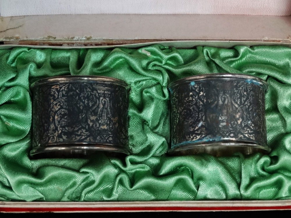 An Indian silver double egg cup - Repousse decorated with deities, 10cm (high), together with a pair - Image 6 of 7