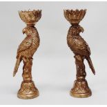 A pair of giltwood candle holders modelled as parrots - perched on a stump, on a circular leaf