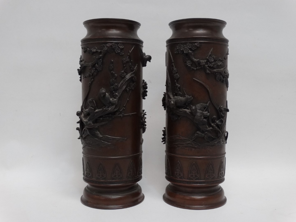 A pair of Meiji period bronze vases - extensively decorated with birds on cherry blossom, height