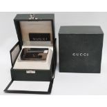 A Gucci bedside clock - cast polished metal, fitted with electronic alarm movement, with retail