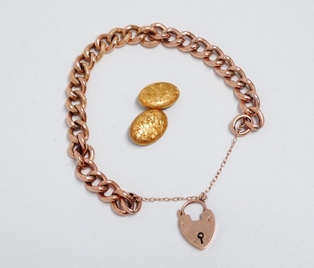 A 9ct gold curblink bracelet - with foliate engraving and a heart shaped clasp, length 16.5cm,