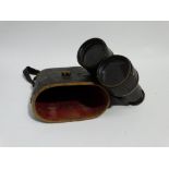 A pair of early 20th century field glasses - brass with black leather mounts, in leather case.