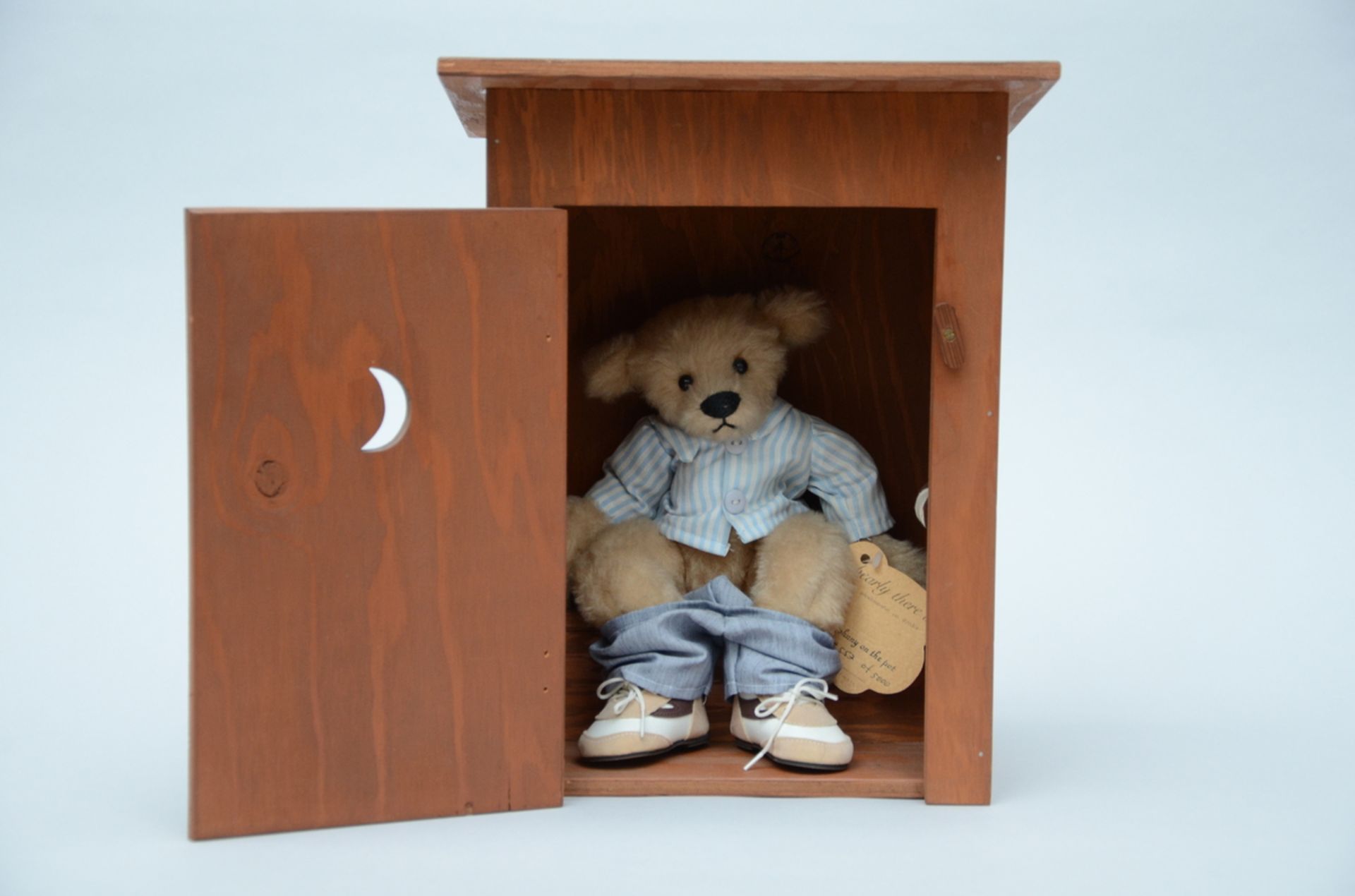 A bear 'Johny on the pot' in wooden box