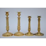 Two pairs of Charles X candlesticks in bronze (h23 and h28cm)
