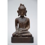 A Burmese seated Buddha in lacquered wood (38x22x17cm) (*)