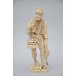 A large Japanese ivory okimono 'fisher', 19th century (marked) (H41)