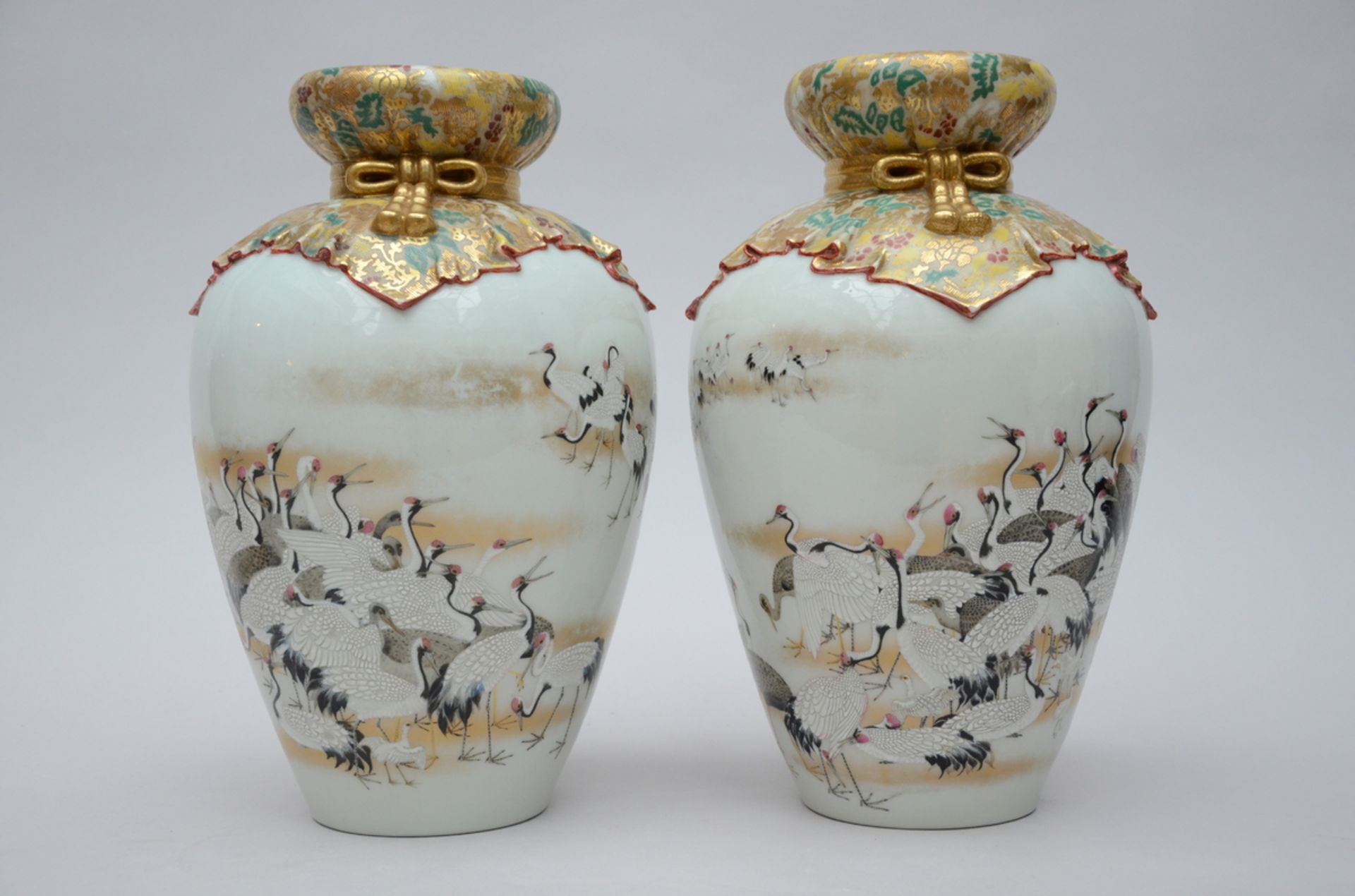 A pair of Japanese porcelain vases with relief decoration, signed (h38cm)