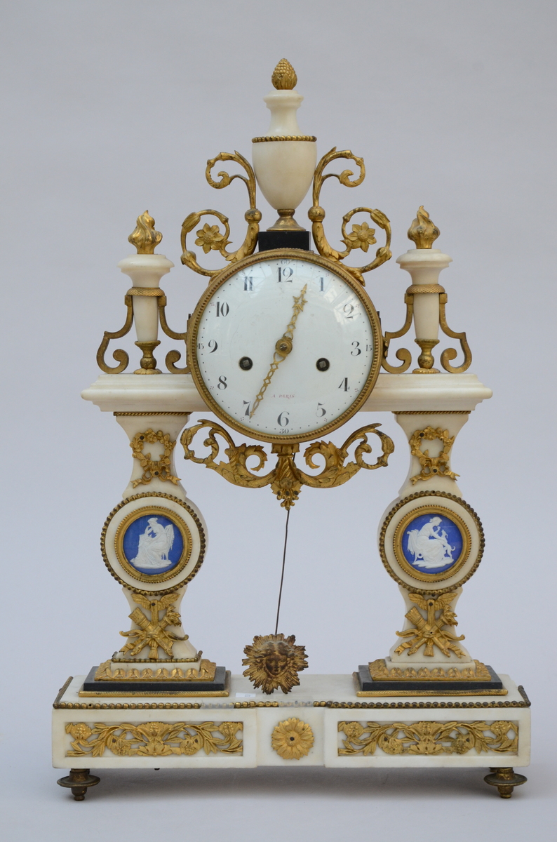 A Louis XVI clock in marble and bronze with Wedgwood plaques (33x53 x11cm)