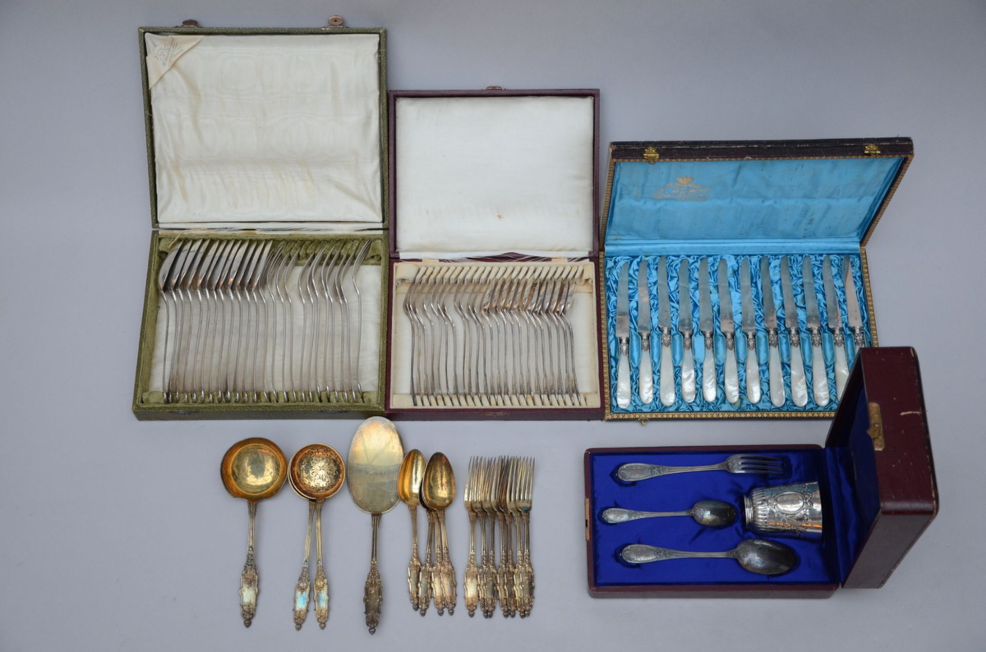 Two different ecrins with silver cutlery, ecrin birth gift, part of a silver menagere in gilt