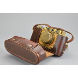 A Russian copy of a WWII Leica camera marked 'Bildberichter No.0407' together with a Leica leather