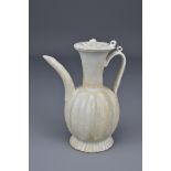 A Chinese Qingbai glaze pottery ewer and cover. Song dynasty (960-1279). The ewer with melon