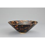 A Chinese Jizhou 'tortoise shell' glazed conical bowl. Potted with a wide flared rim covered in a