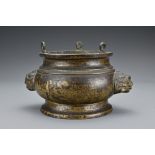 A Chinese 19th century bronze censer. The censer with two large lion mask handles with three loops