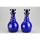 A pair of Bristol blue glass decanters with stoppers, each of mallet form, height 26 cm A very minor