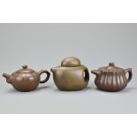 Three vintage Chinese Yixing pottery tea pots in varying designs. Each with makers seals to base.