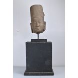 A LARGE Southeast Asian carved stone head. Cambodian, Khmer style. Mounted on large wooden stand.