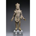 A Cambodian bronze figure of Vishnu. The four-armed figure standing wearing sampot with long
