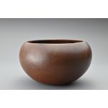 A Chinese Yixing Zisha stoneware alms bowl. The rounded bowl finely potted in a rich dark brown clay