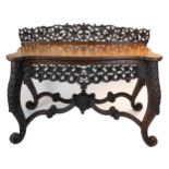 An Anglo-Indian carved hardwood console table, 19th century, With pierced foliate ledge back,