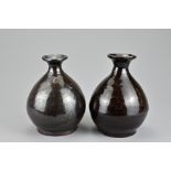 Two Chinese brown glazed pear-shaped bottle vases. Thickly-potted with ovoid body leading into a