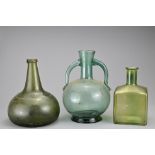 An 18th Century Onion Shaped Wine Bottle, together with two 19th century bottles, tallest 20 cm,