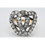 An antique ring with diamonds set in white metal double heart setting fixed to yellow metal