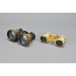 A pair of mother-of-pearl opera glasses together with one other pair in brass. 10-11.5cm width (2)