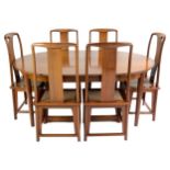 A Chinese hardwood dining suite including six chairs with woven seats and a circular extension table