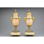 A Pair of French Alabaster Mantel Urns, with cloisonnŽ, ormolu and pine cone finials, height approx.