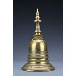 A Sino-Tibetan polished bronze Stupa. The dome shaped box and cover on splayed foot with tall