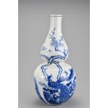 A Chinese blue and white porcelain vase. The double gourd shaped vase decorated in underglaze blue