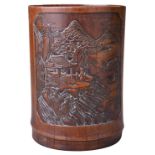 A CARVED BAMBOO BRUSH POT, 19TH CENTURY. Carved in relief with coastal landscape depicting figures