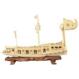 A CHINESE CARVED IVORY MODEL OF A BOAT, 19TH CENTURY. The pleasure boat carved and pierced with