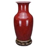 A CHINESE FLAMBÉ GLAZED VASE, 18TH CENTURY. Covered in a red mottled glaze thinning into a purple