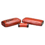THREE CHINESE RED LACQUER PILLOWS, 19/20TH CENTURY. Each stuffed with added decoration and