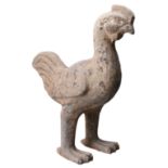 A CHINESE GREY POTTERY MODEL OF A CHICKEN, HAN DYNASTY (206BC-220AD). The moulded figure standing