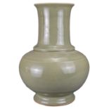 A CHINESE CELADON HU-FORM PORCELAIN VASE, QING DYNASTY. The heavily potted vase with globular body
