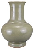 A CHINESE CELADON HU-FORM PORCELAIN VASE, QING DYNASTY. The heavily potted vase with globular body