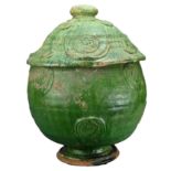 A LARGE CHINESE GREEN-GLAZED BUDDHIST JAR, SONG/YUAN DYNASTY. Heavily-potted with both cover and jar