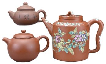 THREE CHINESE YIXING POTTERY TEA POTS. The first with glazed floral decoration, with four-